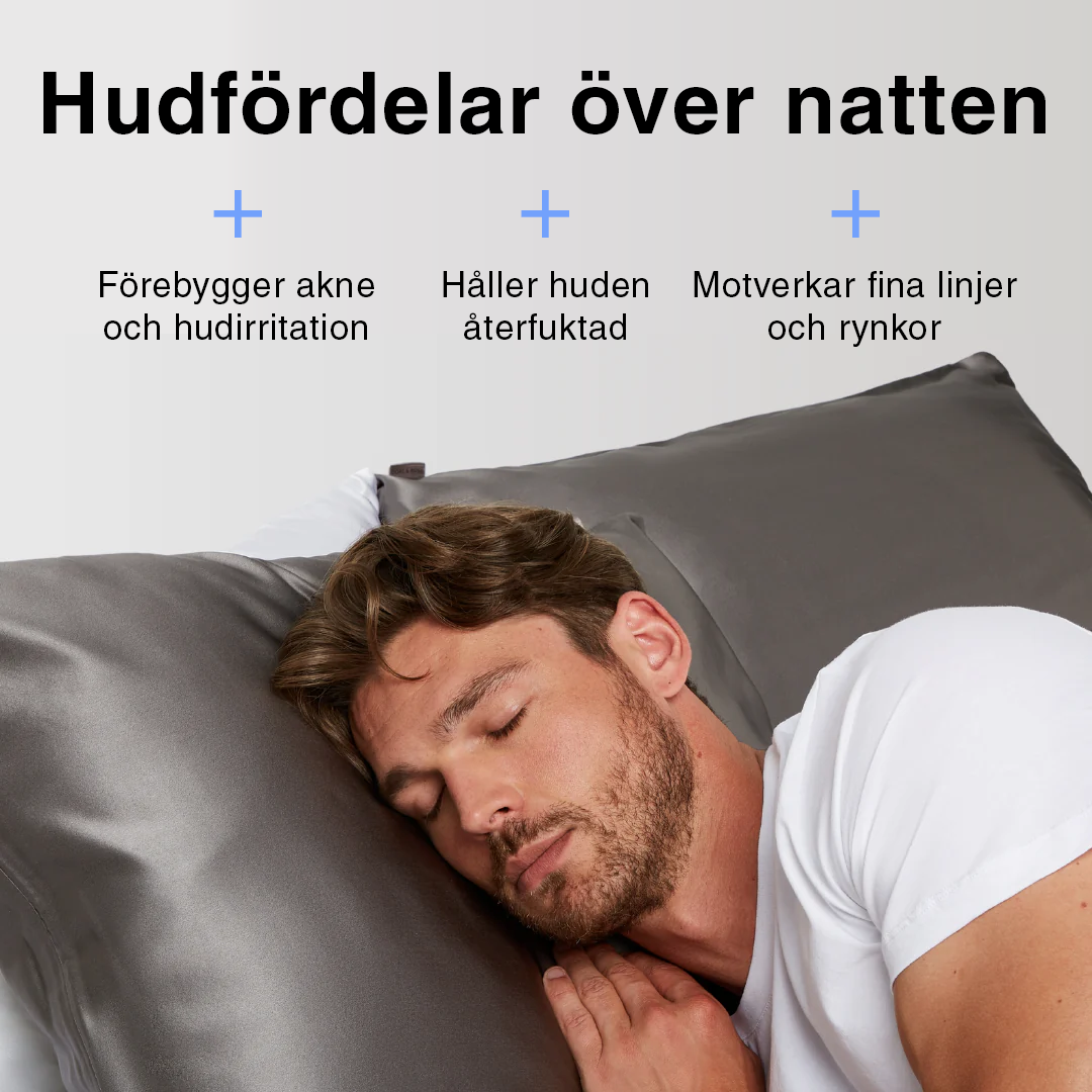 Grått sidenörngott i bäddad säng – mjukt, lent och skonsamt mot huden