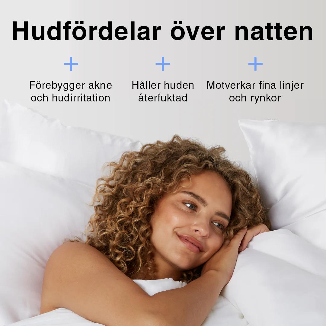 Vitt sidenörngott i bäddad säng – mjukt, lent och skonsamt mot huden